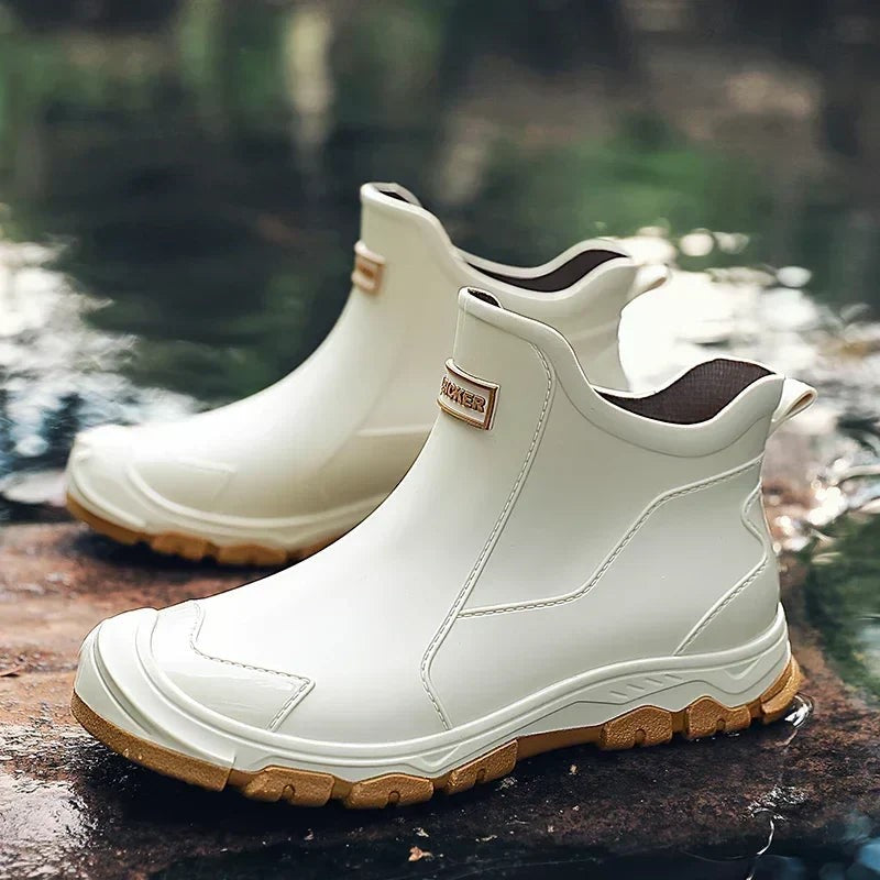 Cream waterproof ankle rain boots with tan rubber sole and pull tab
