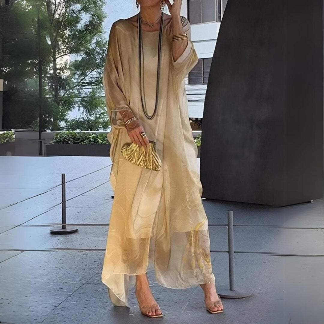 Model walking in beige swirl-print kaftan maxi dress outdoors