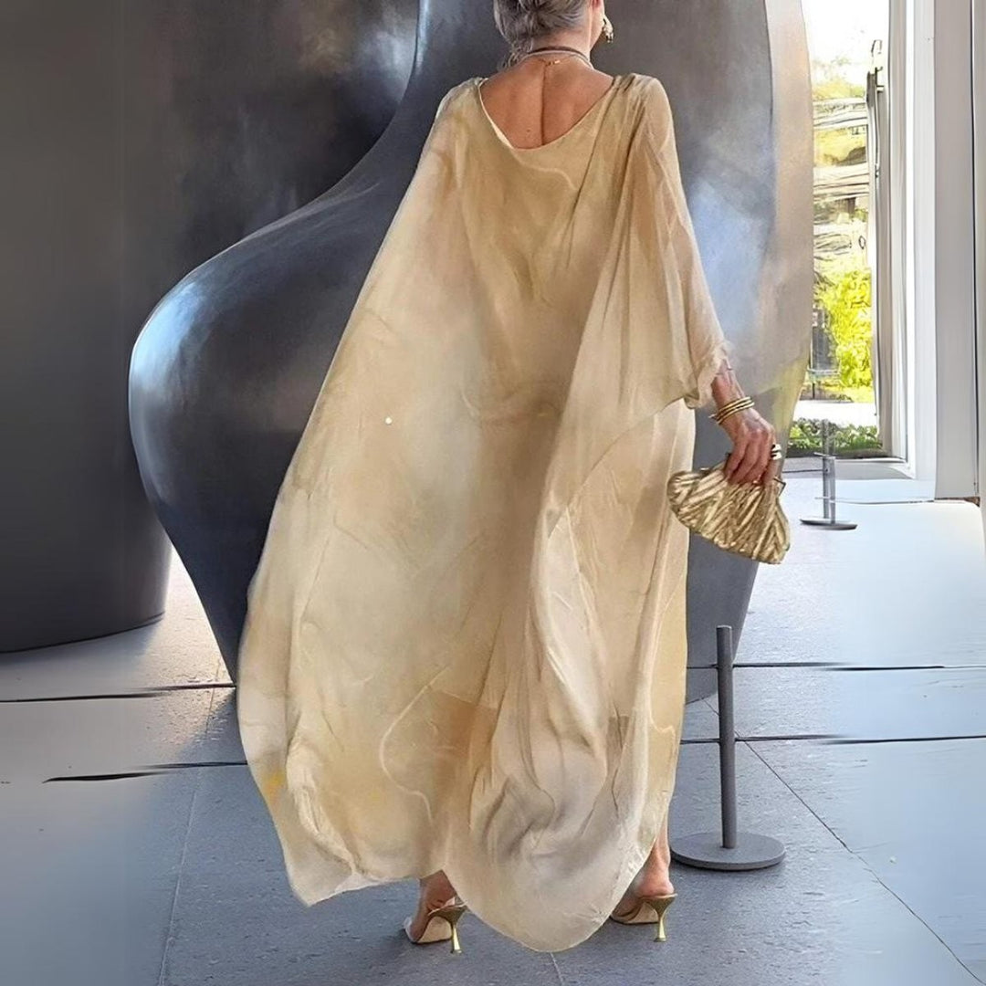Back view of beige batwing maxi dress with draped sheer fabric