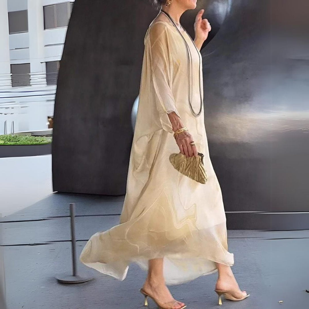 Side profile of beige marble-print flowy maxi gown with long sleeves