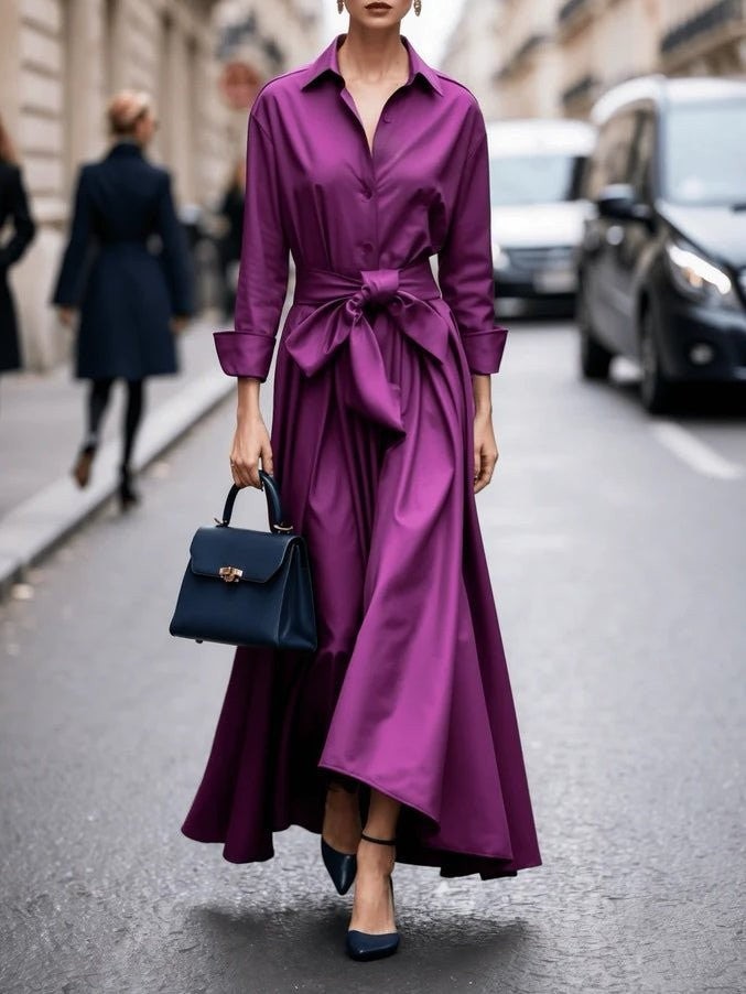 Magenta collared shirt dress with tie waist and high-low hem, styled with navy handbag