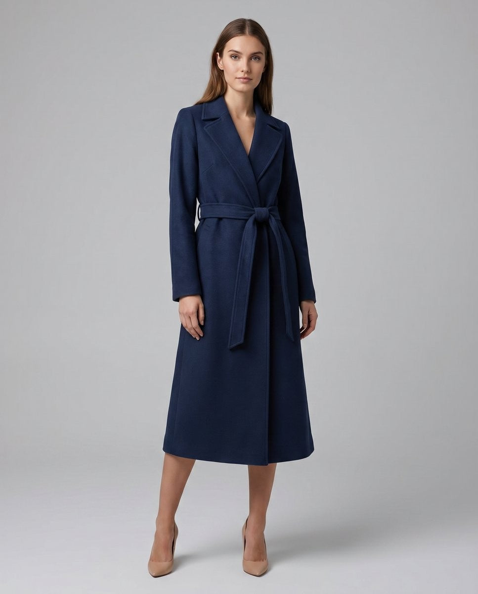Belted navy long coat with notch lapel paired with nude pumps