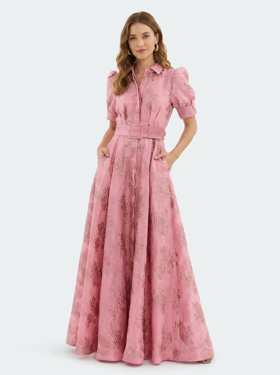 Model wearing pink belted shirt dress with collared neckline and metallic floral print