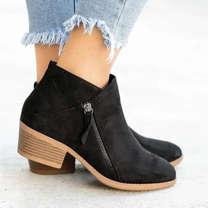 Black suede ankle boot featuring side zip detail and low block heel