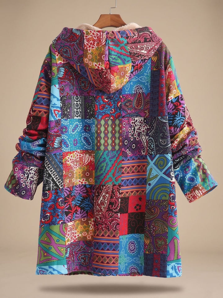 back view of colorful boho patchwork hooded jacket on wooden hanger