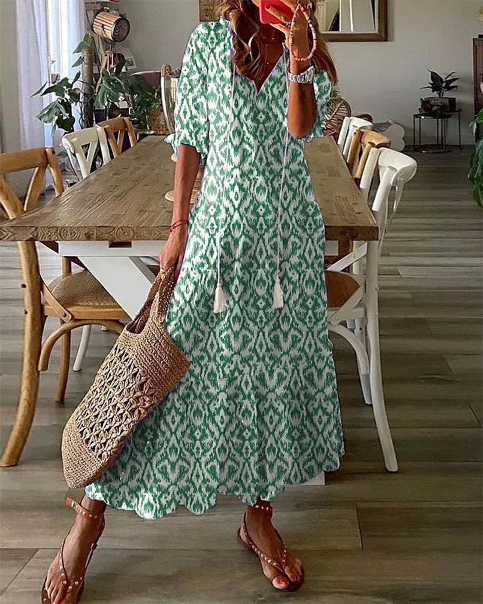 Green and white ikat print boho maxi dress with tassel tie neckline