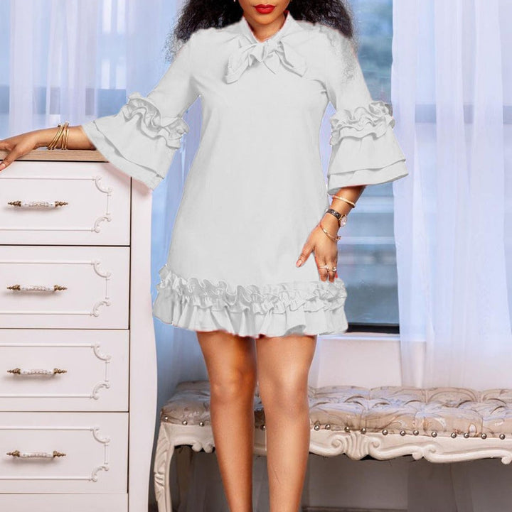 white bow-neck shift dress with tiered ruffle sleeves and hem