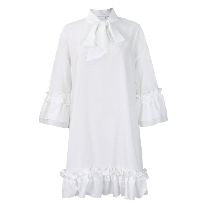 white tie-neck tunic dress with ruffled cuffs and hemline, flat lay