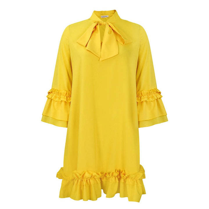 yellow bow-collar tunic dress with ruffled sleeves and hem, flat lay