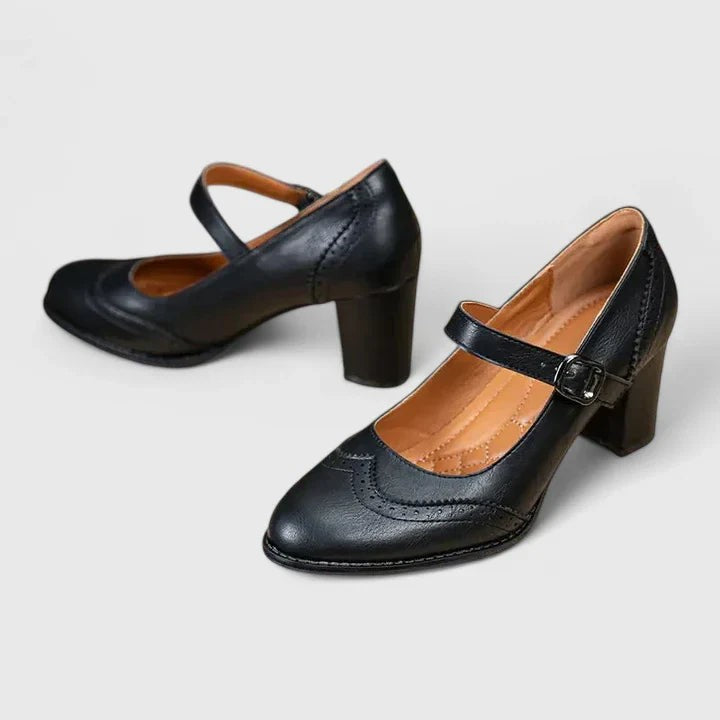Black leather Mary Jane pumps with wingtip brogue detail and block heel