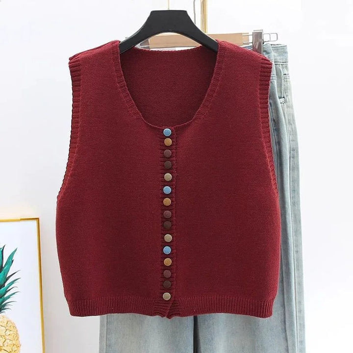 Burgundy knit sweater vest with colorful button-front detail on hanger