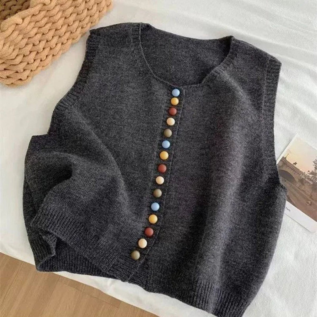 Charcoal knit vest featuring colorful button front, flat lay view