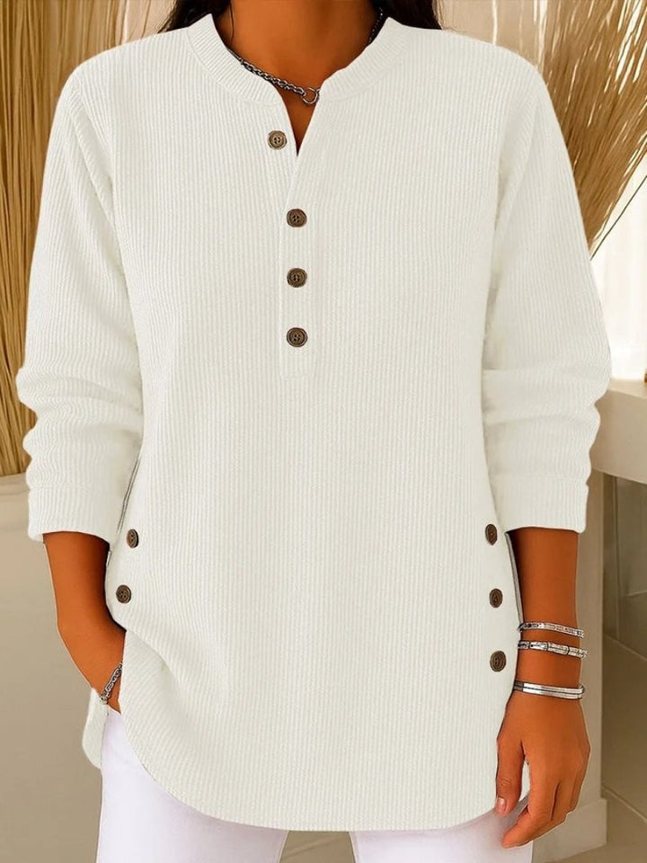 white ribbed knit henley blouse with wooden button accents and long sleeves