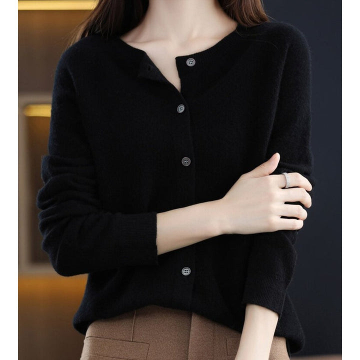 Black knit cardigan sweater with button front, round neckline close-up