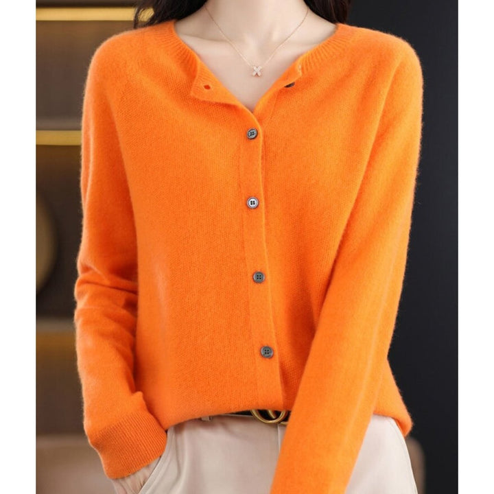 Bright orange knit cardigan sweater with button closure, close-up