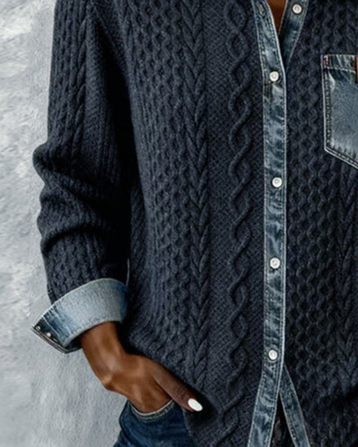 Close-up of dark cable-knit shirt with denim placket and rolled cuff