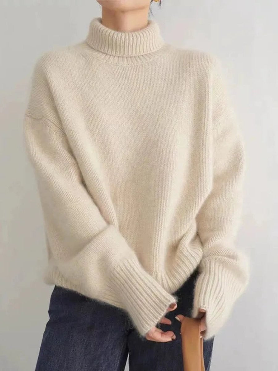 Ivory cashmere turtleneck sweater featuring chunky ribbed knit texture