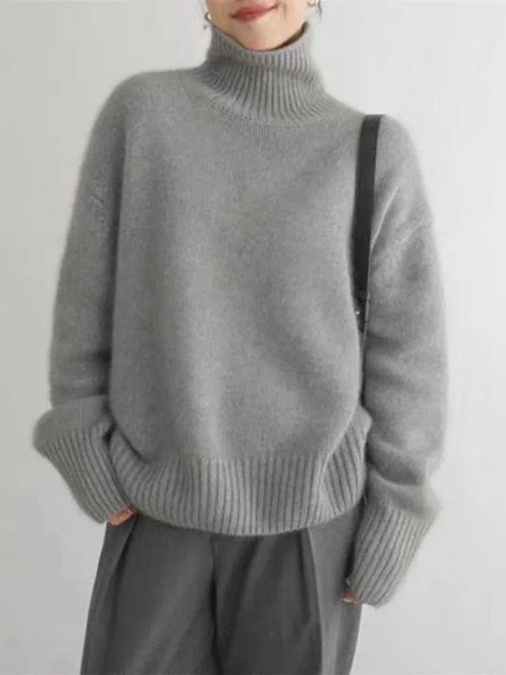 Heather gray knit turtleneck sweater with dropped shoulders and ribbed hem