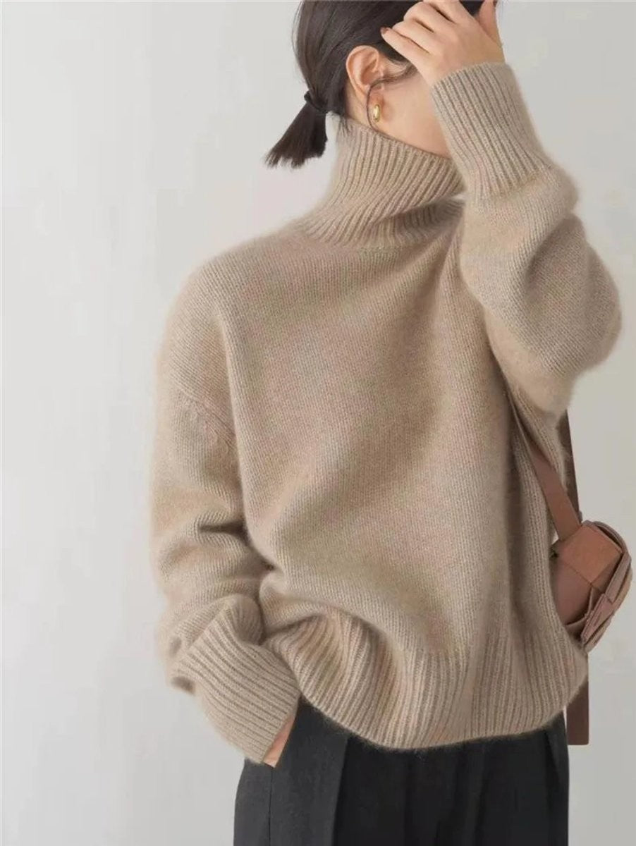 Camel oversized turtleneck sweater paired with a brown crossbody bag