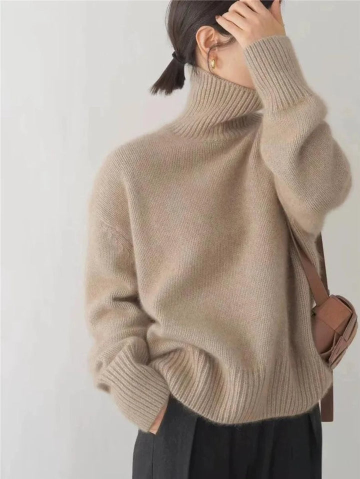 Camel oversized turtleneck sweater paired with a brown crossbody bag