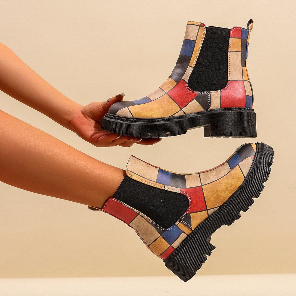 Colorful patchwork Chelsea boots with red, blue, and mustard color-block design