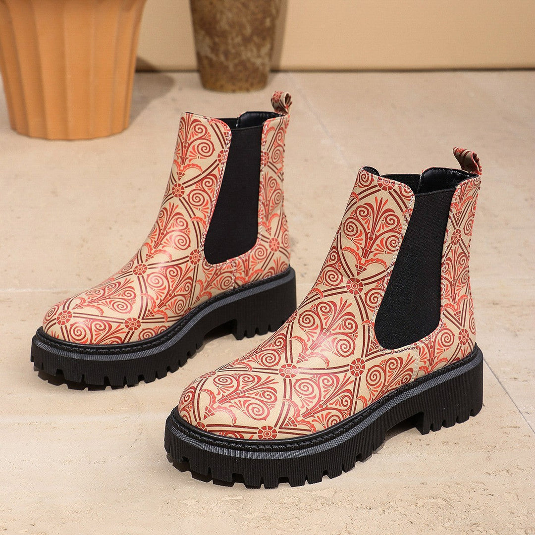 Cream Chelsea boots featuring red swirl and floral print with black elastic panel