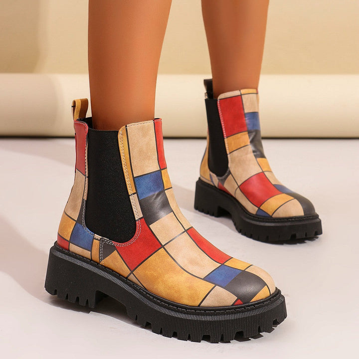 Colorful geometric patchwork Chelsea boots worn on model's feet
