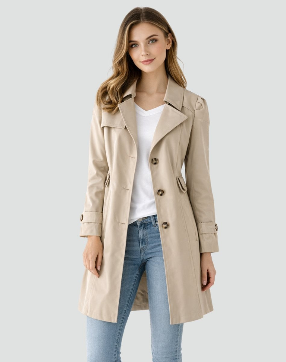 beige double-breasted trench coat styled with white top and jeans