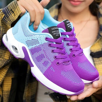 Woman holding purple and blue mesh sneaker with white platform sole