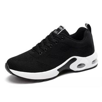 Black mesh sneaker featuring white platform sole and air-cushioned heel