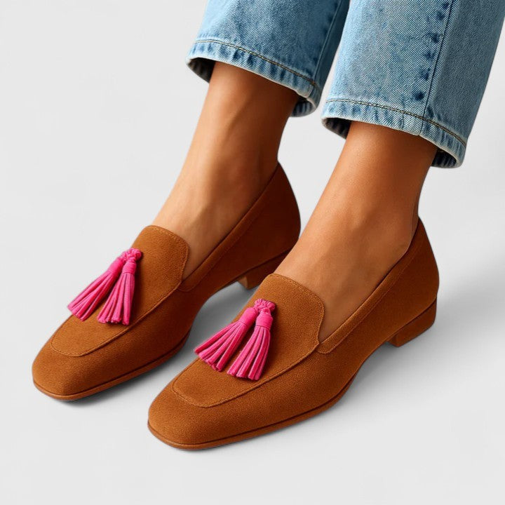 Cognac suede loafers with pink tassel detail, worn with cuffed jeans