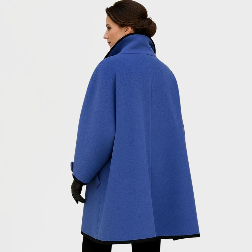 Back view of blue swing coat showing oversized silhouette and black trim