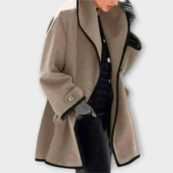 Taupe oversized swing coat featuring shawl collar and black piping detail