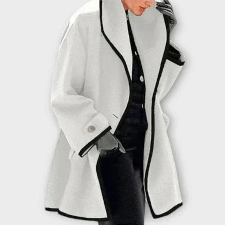 White wool-blend swing coat with black contrast trim and wide collar