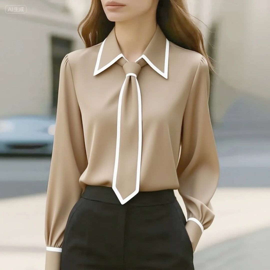Beige tie-neck blouse featuring white piping and pointed collar