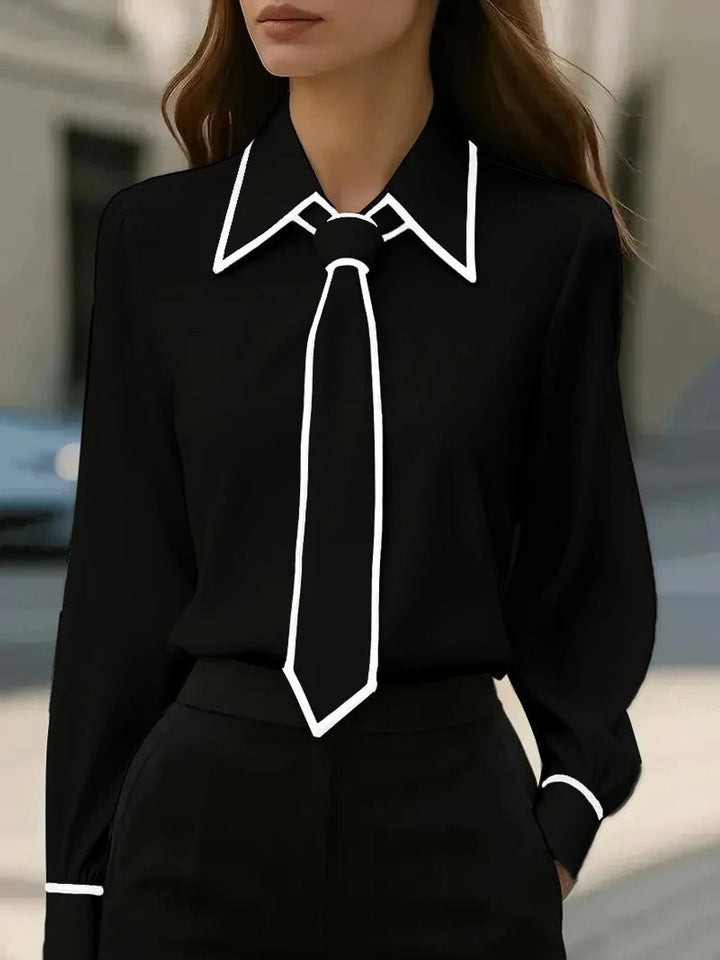 Black long-sleeve blouse with white contrast trim and tie collar