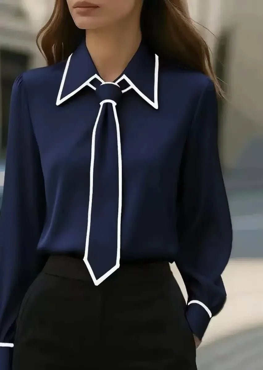 Navy tie-neck blouse with white contrast trim and pointed collar