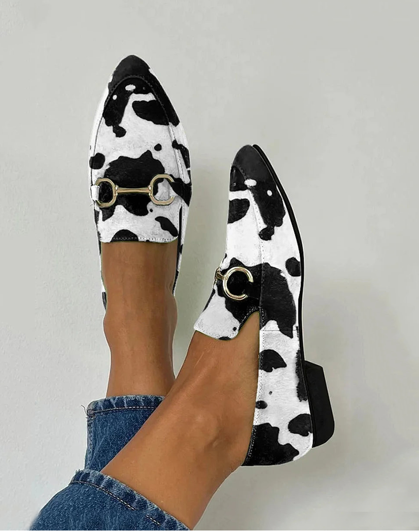 Cow print loafers with pointed toe and gold horsebit buckle detail