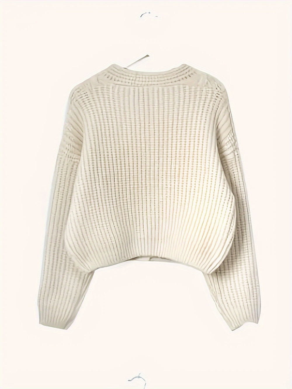 Cream ribbed knit cardigan displayed flat on hanger, back view