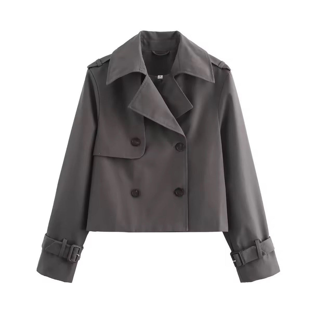 Charcoal gray cropped trench coat with double-breasted closure and buckle cuffs