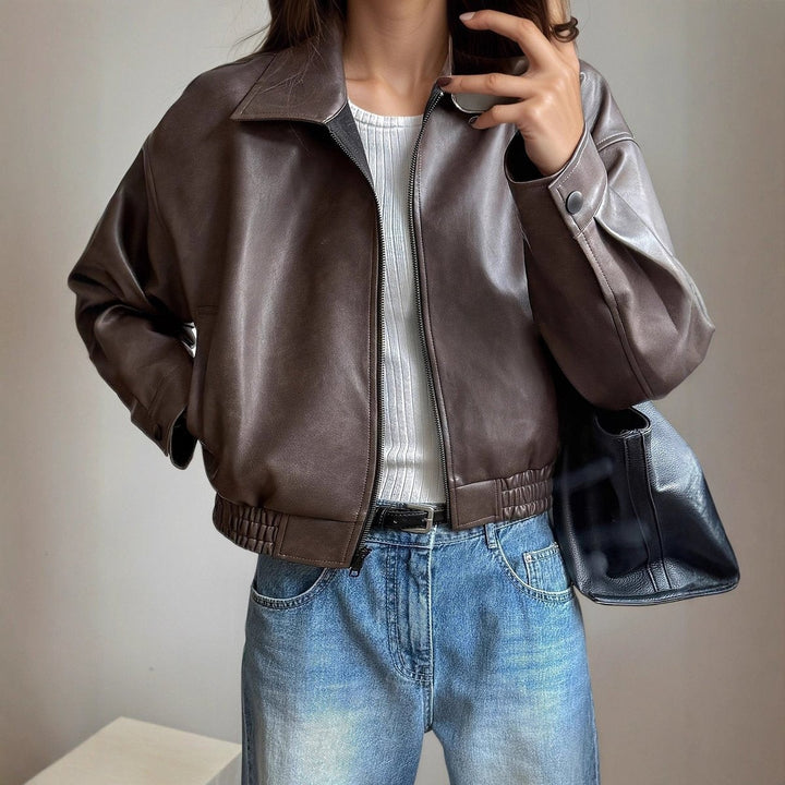 Cropped brown faux leather jacket styled with white top and jeans
