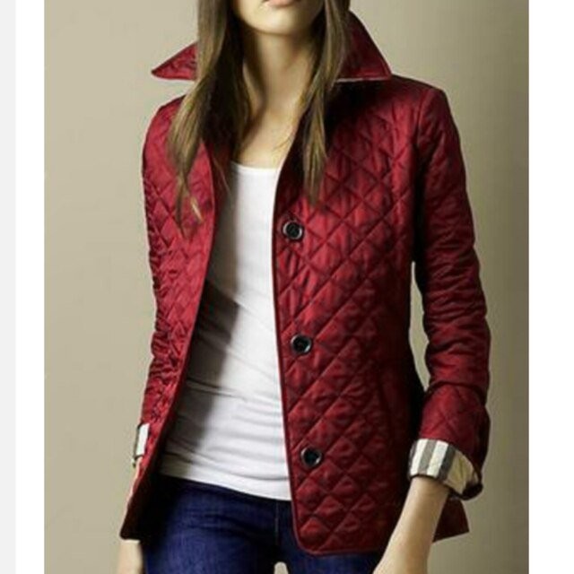 Burgundy quilted jacket featuring plaid cuffs and button-front tailored design