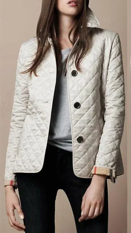Cream quilted button-through jacket with tailored collar and plaid cuff lining