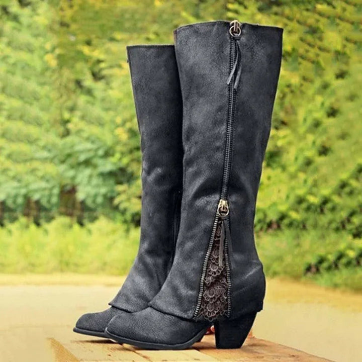 Black knee-high boots featuring side zip and lace accent panel
