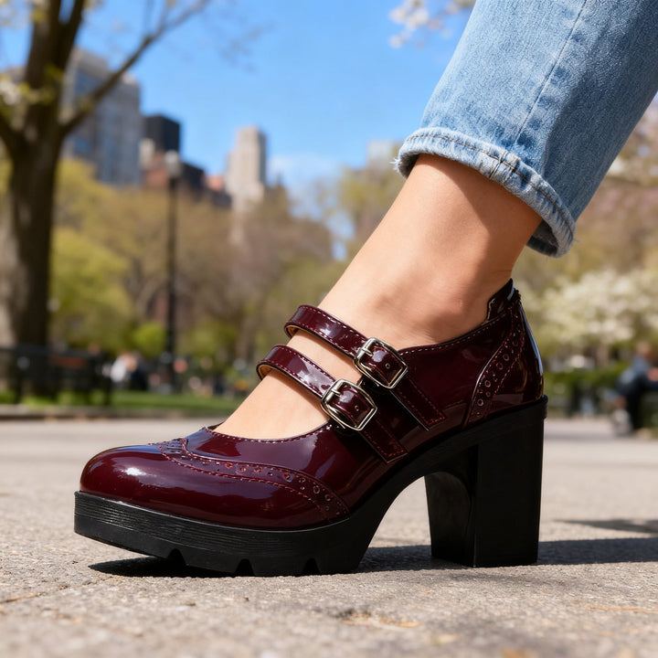 Burgundy patent leather Mary Jane heel with silver buckles and lugged platform sole
