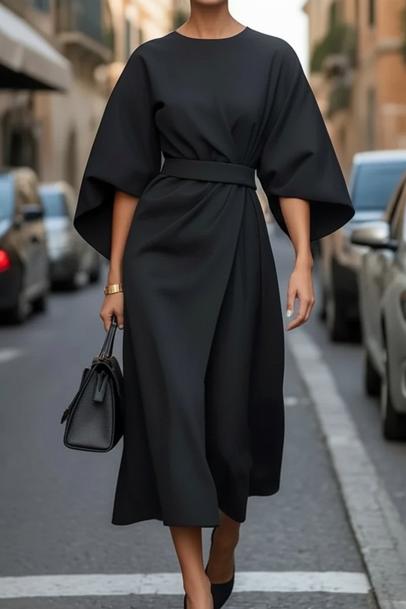 Black belted midi dress featuring cape sleeves and draped front skirt