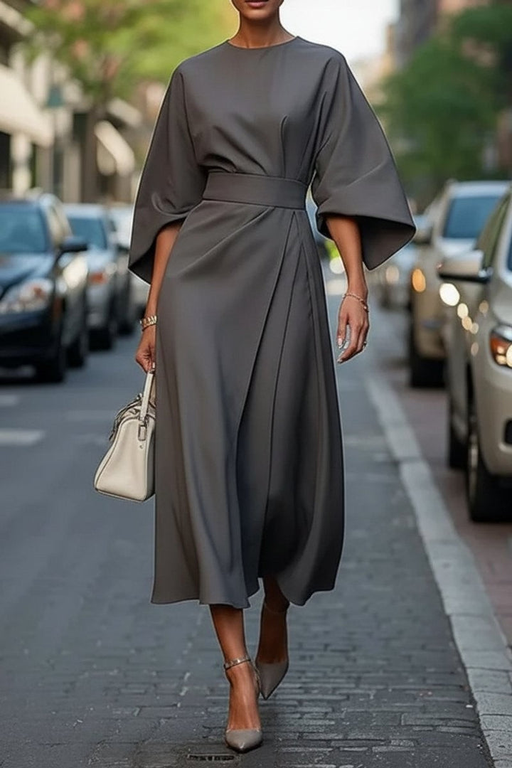 Charcoal gray belted midi dress with draped skirt and cape sleeves