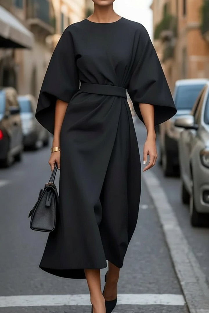 Black cape-sleeve midi dress with belted waist and draped wrap skirt