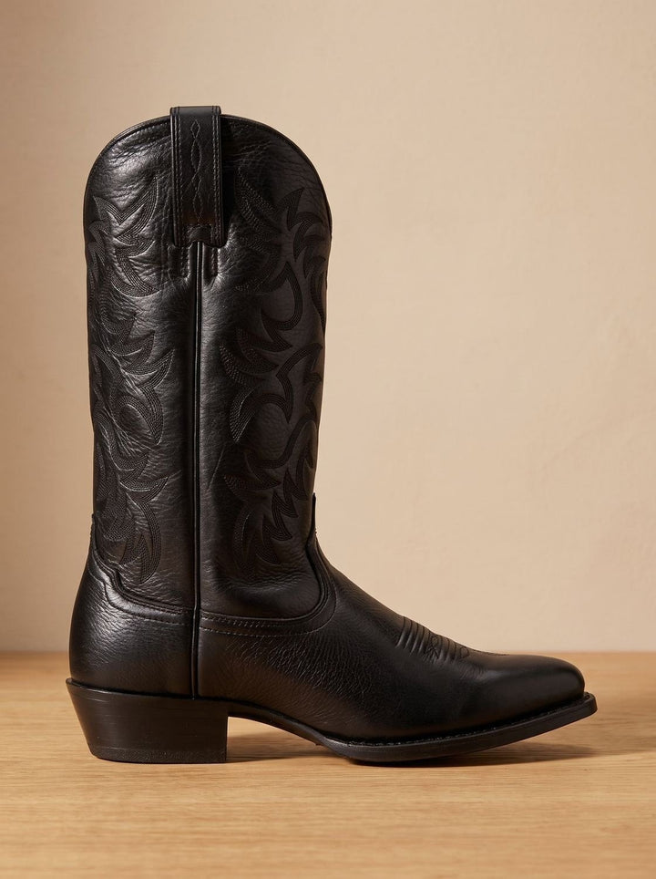 Side view of black cowboy boot showing embroidered stitching and block heel
