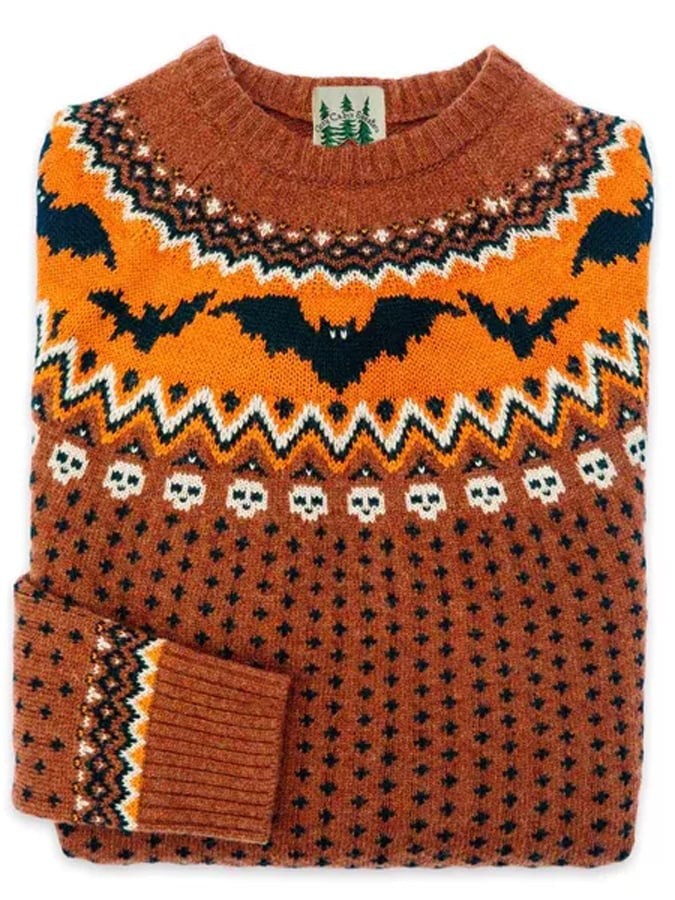 Rust orange crew-neck sweater with knit bats and skull motif